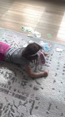 Little girl drawing on a carpet